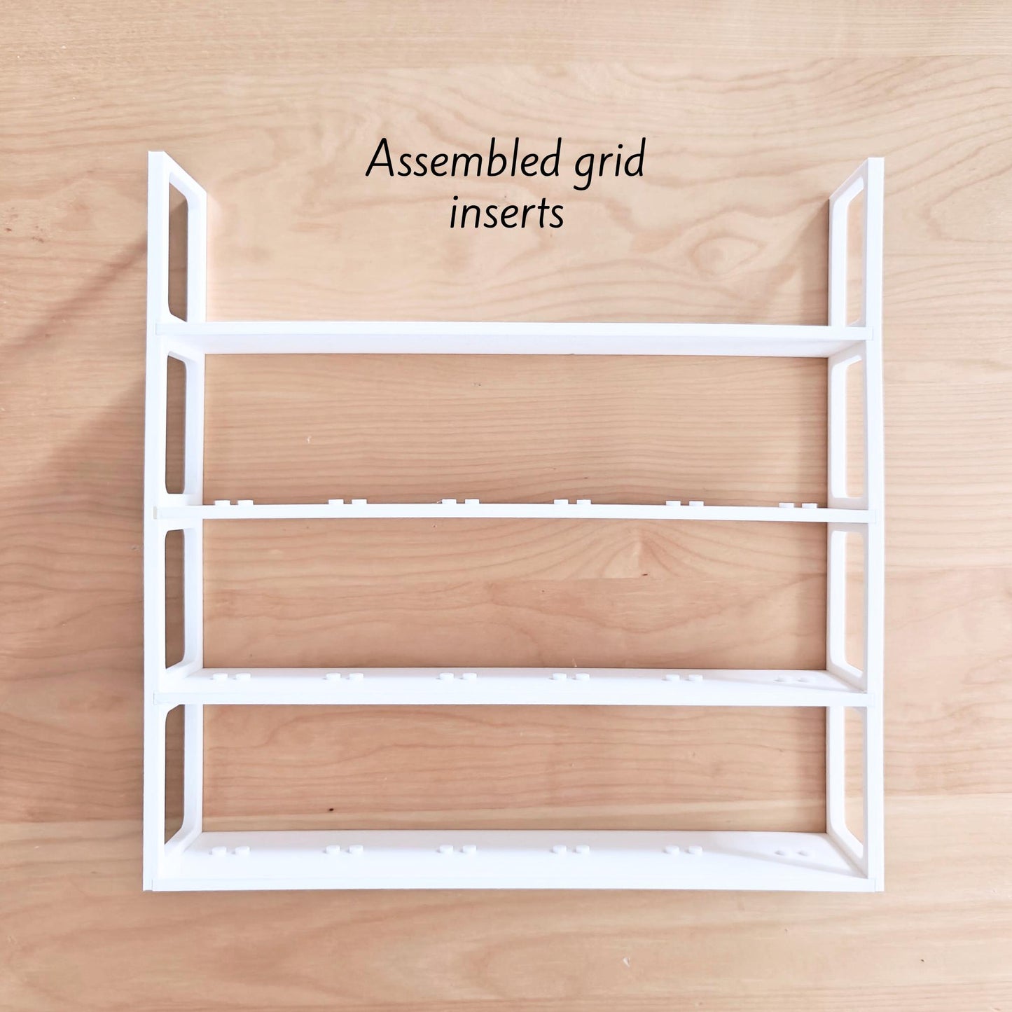 White grid insert structure with shelves for LEGO minifigures
