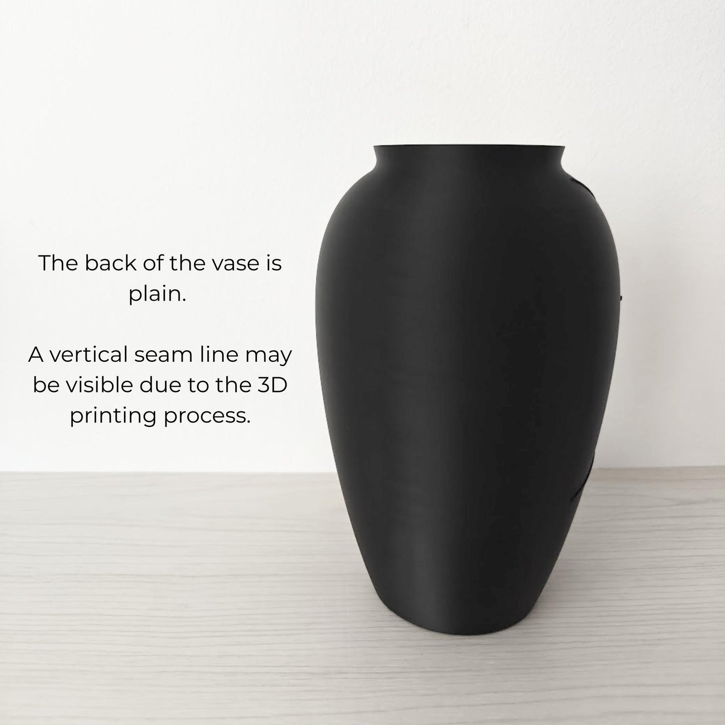 Plain back side of the black vase showing simple smooth design.