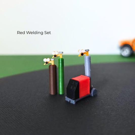 Red miniature welding set with three gas cylinders, detailed regulators and a wheeled welding machine.