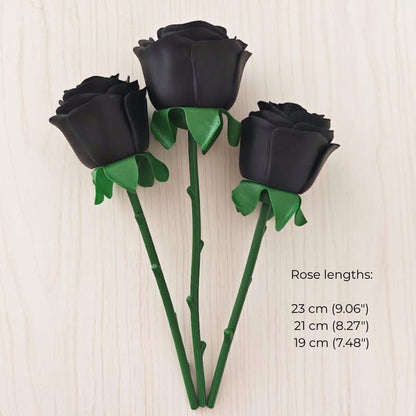 Three black faux roses with green stems in lengths of 19 cm, 21 cm and 23 cm.