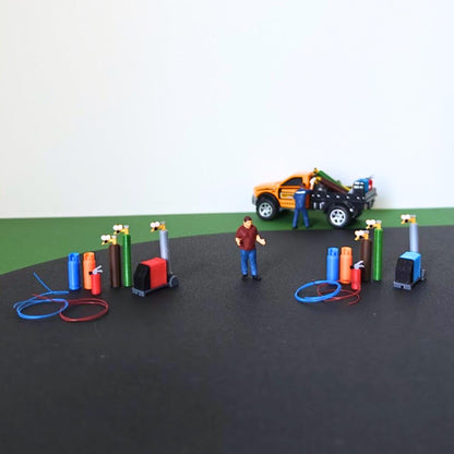 Red and blue workshop utility sets displayed together with a scale figure and model pickup truck.