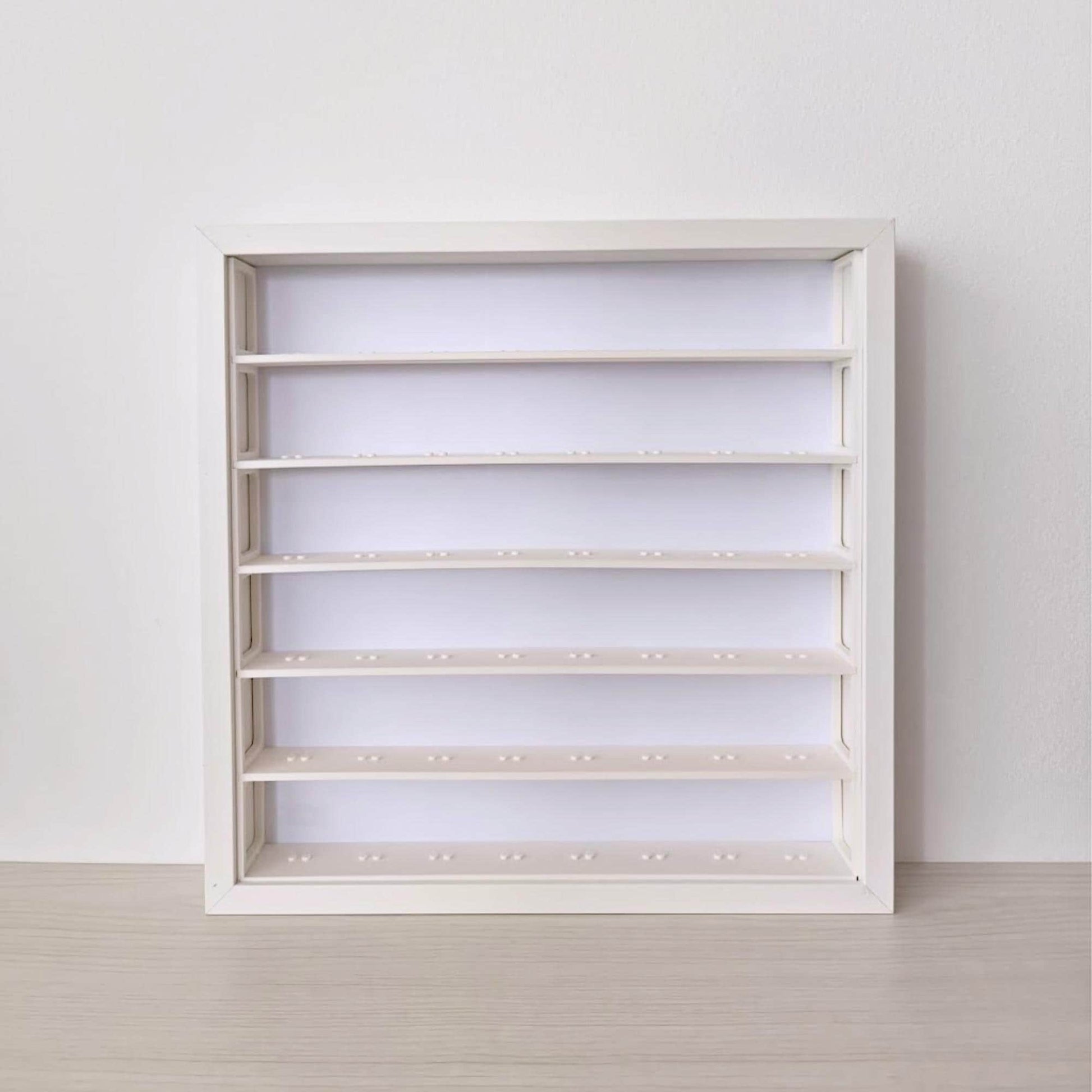 Front view of an empty white SANNAHED frame fitted with the six-row minifigure display insert.