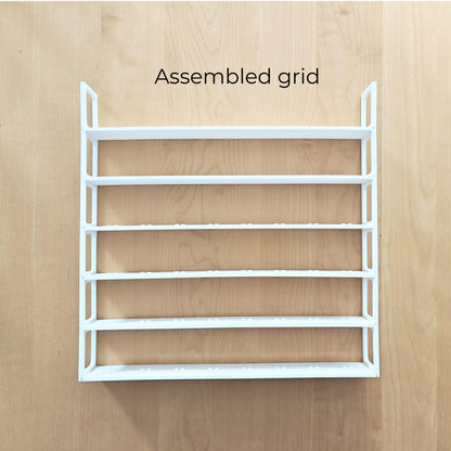 Fully assembled white six-row minifigure display grid shown outside the frame.
