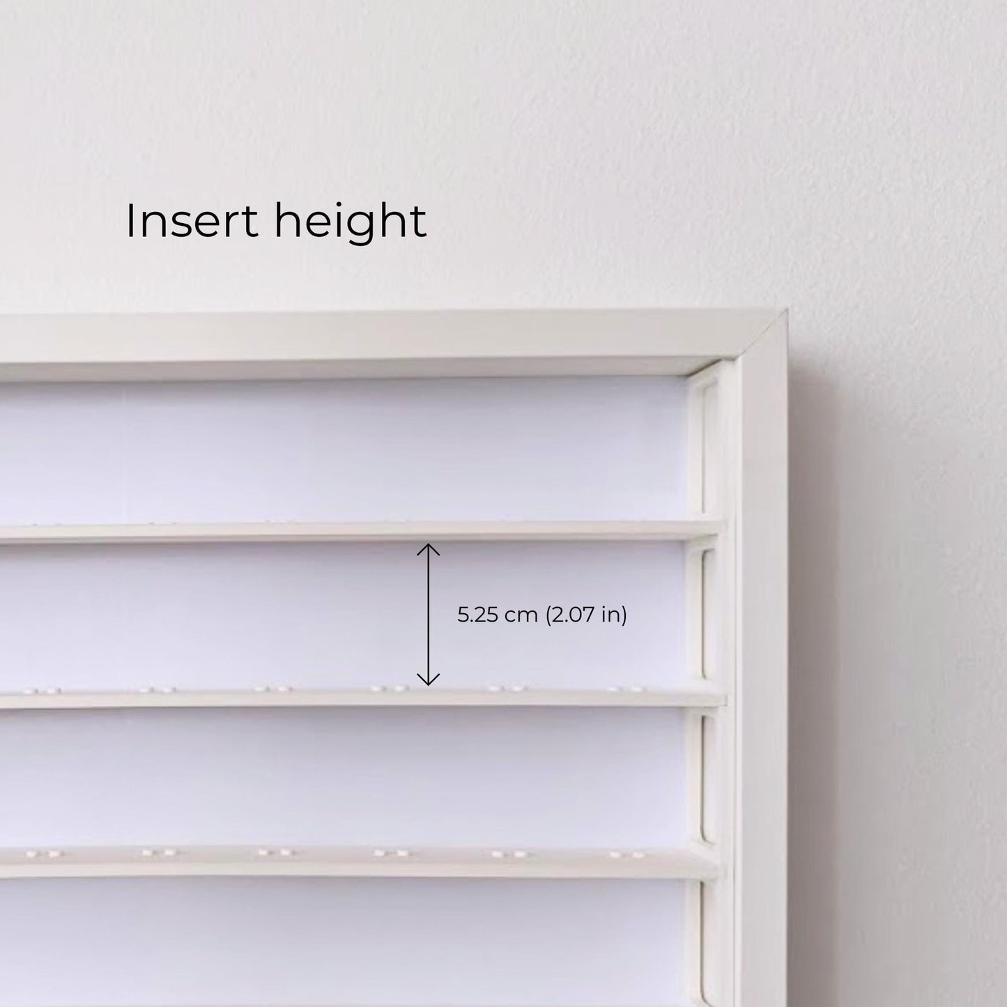 Close-up of the white display insert showing 5.25 cm (2.07 in) of space between the shelves.
