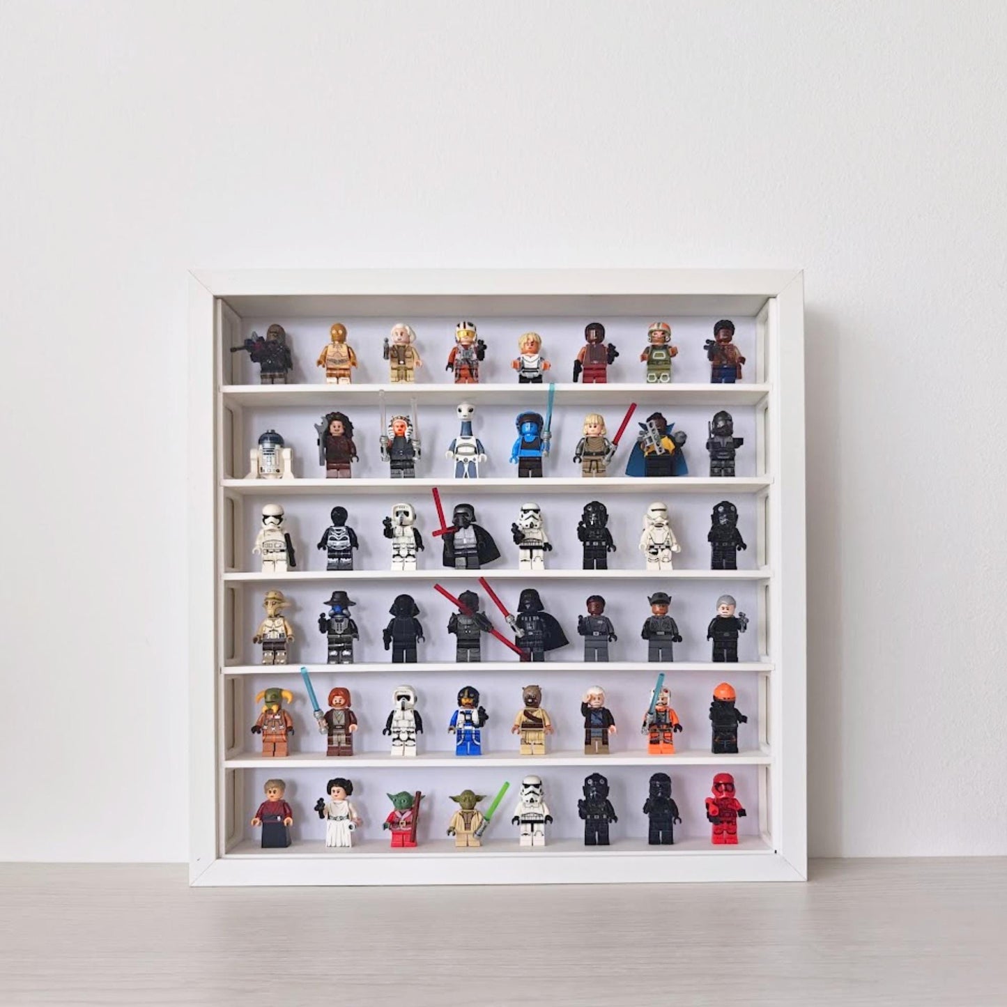 White SANNAHED 35 × 35 cm frame with a six-row display grid holding 48 collectible minifigures