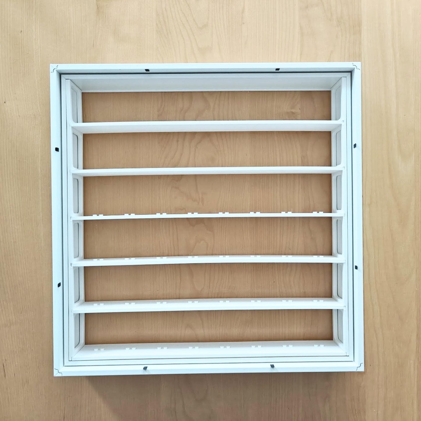 Assembled white display grid fitted inside the removable inner section of the SANNAHED frame.