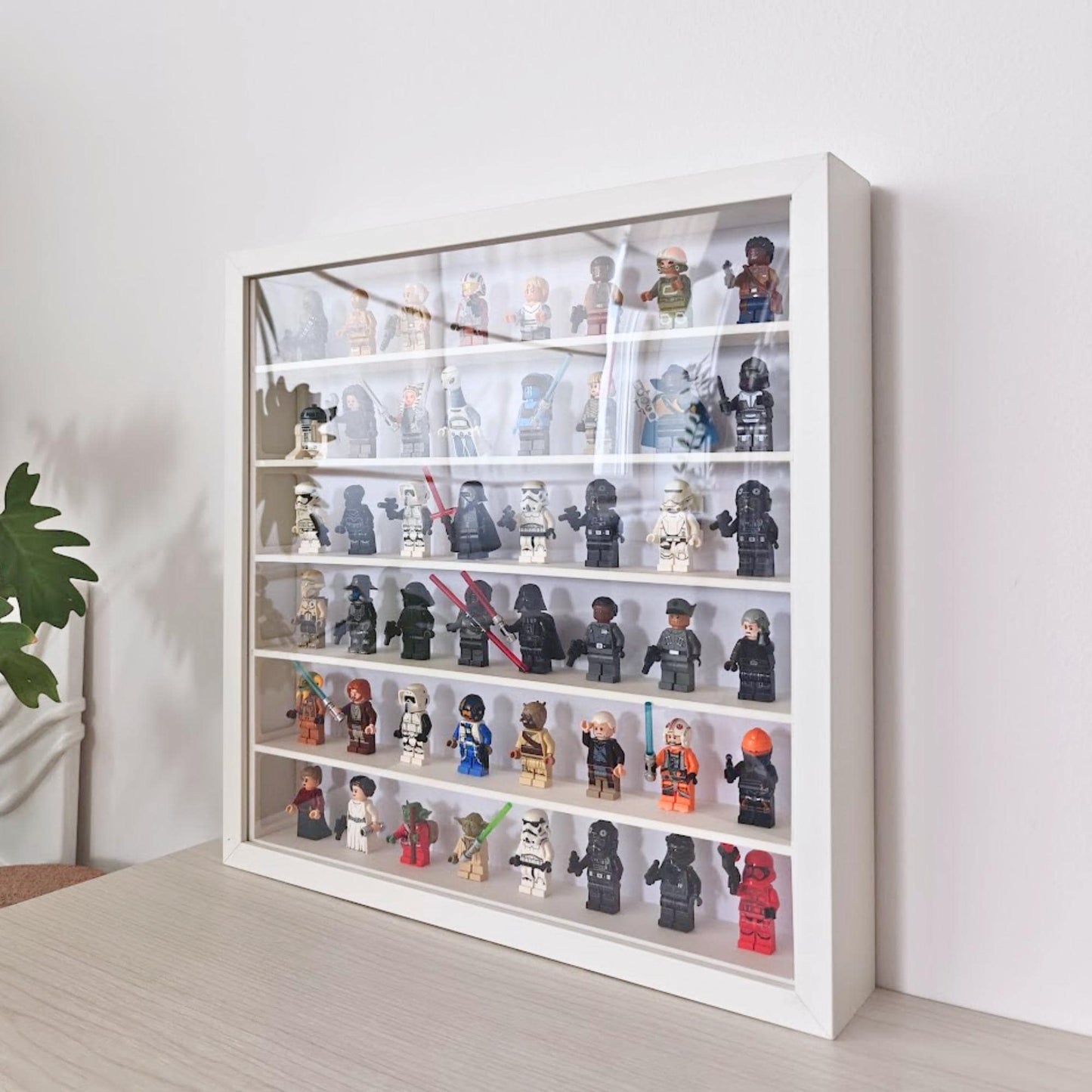 Angled view of the SANNAHED display frame filled with collectible minifigures with front transparent panel.