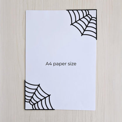 Spiderweb corner bookmarks shown on A4 paper for size comparison