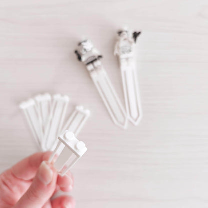White minifigure bookmark clip shown in hand with attached brick studs