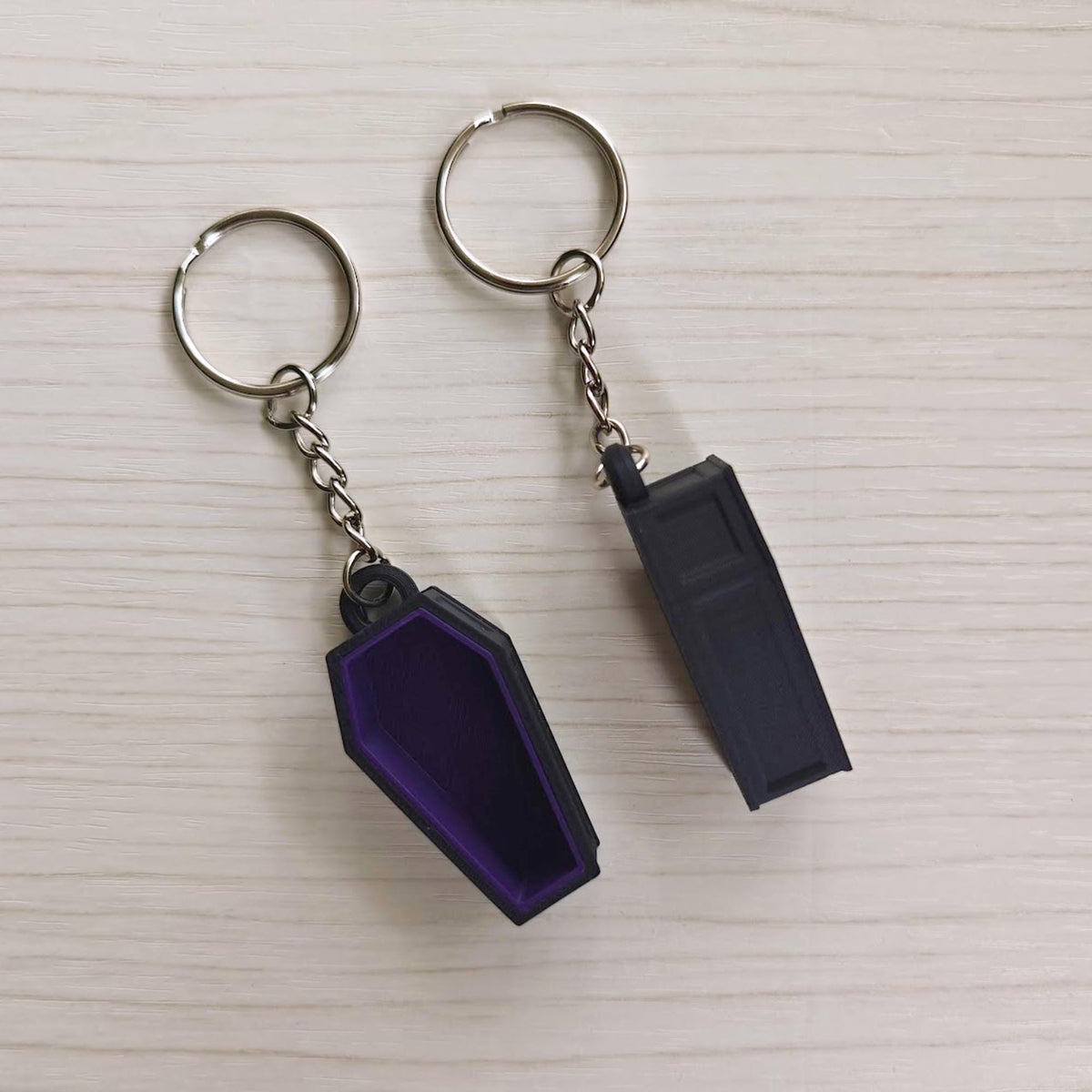 Purple coffin keychain shown from the front and back