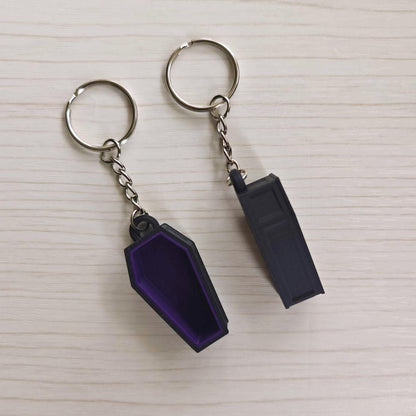 Purple coffin keychain shown from the front and back