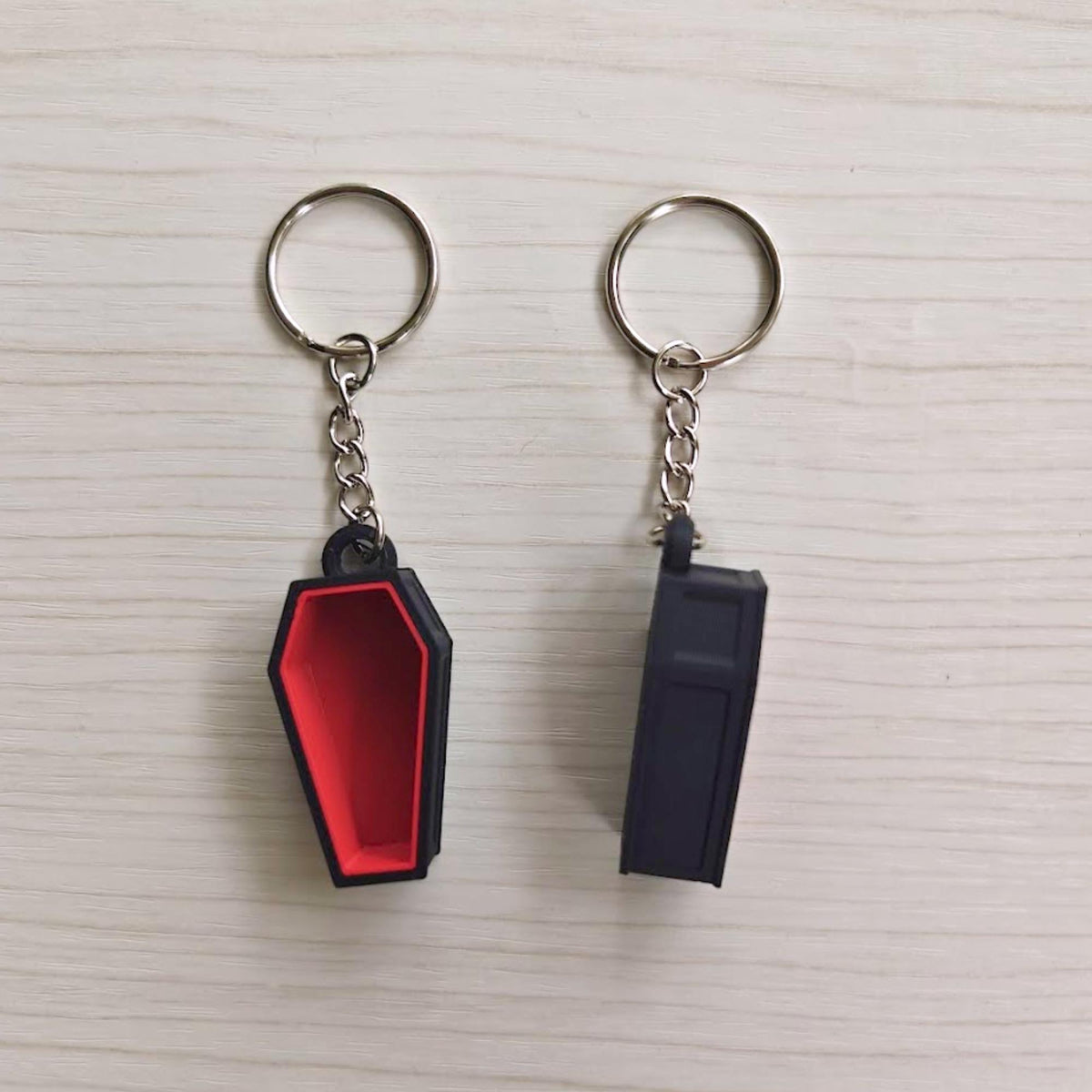 Red coffin keychain shown from the front and back