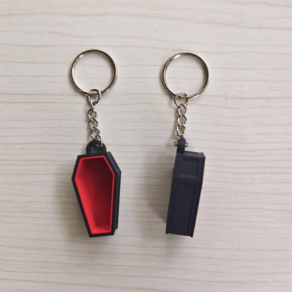 Red coffin keychain shown from the front and back