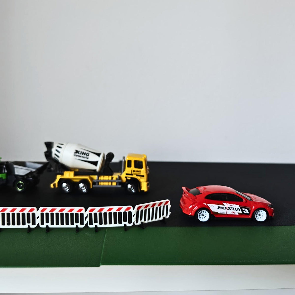 1:64 scale barricades displayed with construction truck and model car