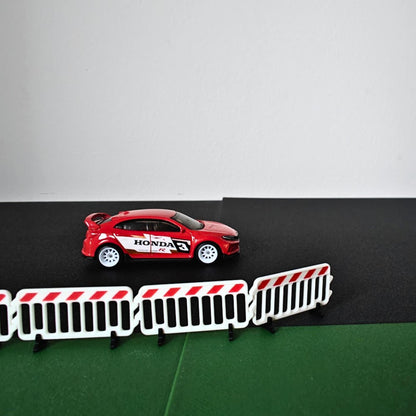 1:64 scale crowd control barricades displayed with a red model car diorama