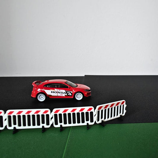 1:64 scale crowd control barricades displayed with a red model car diorama