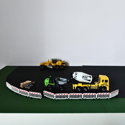 Miniature roadwork scene with connected crowd control barriers and construction vehicles