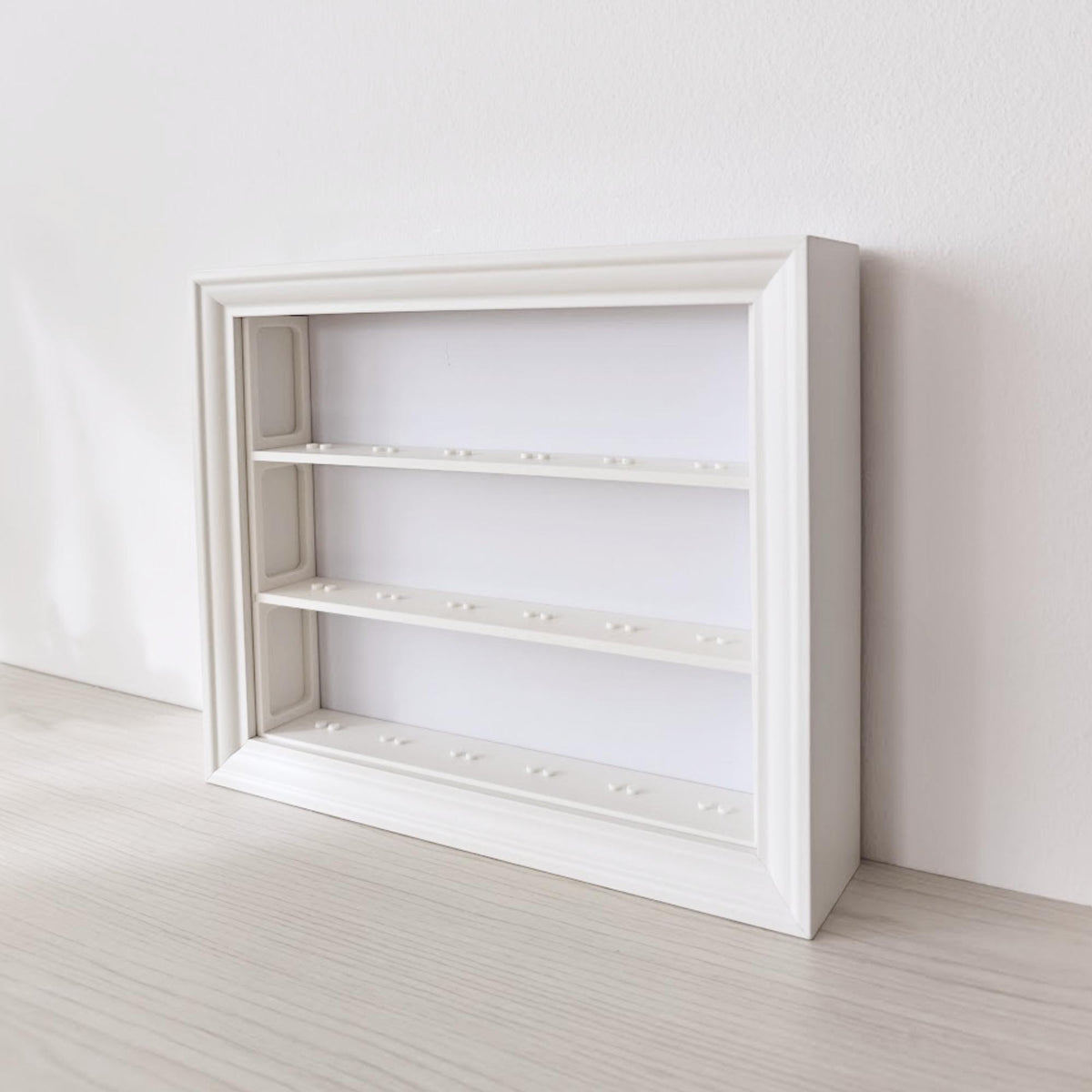 Angled view of empty horizontal IKEA VÄSTANHED frame with 3D printed shelf inserts.