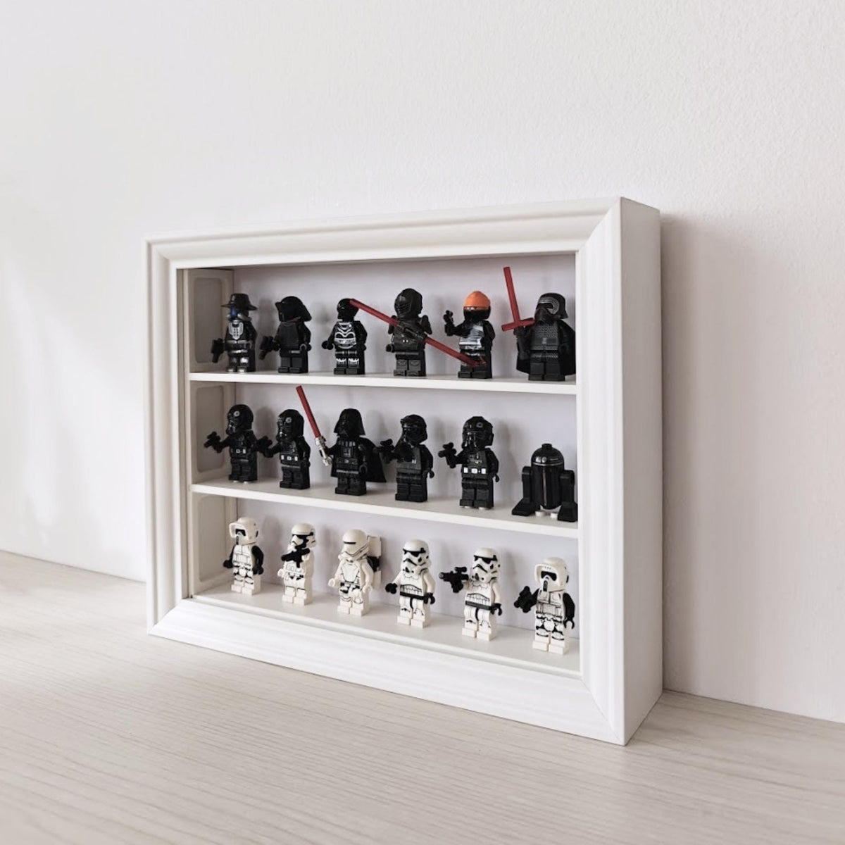 Angled view of horizontal VÄSTANHED frame with three shelves displaying a minifigure collection.