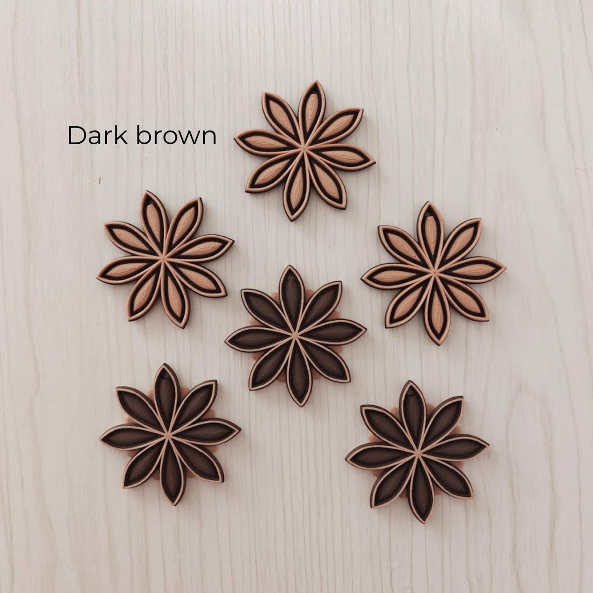 Dark brown star anise ornaments in mixed warm brown color combinations.