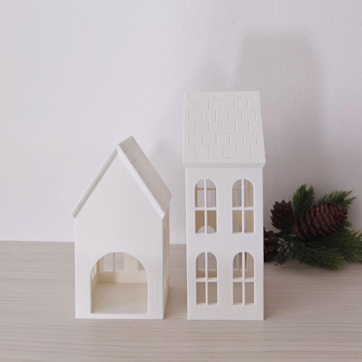 Side view of 3D printed house candle shades with pitched roofs