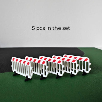 Set of five miniature white and red roadwork barricades with black feet