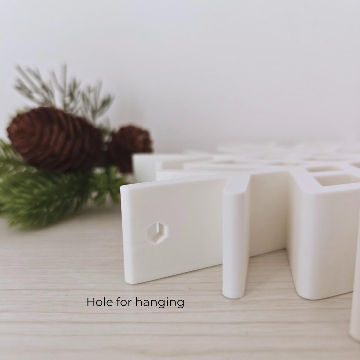 Side detail showing the hanging hole on a thick 3D printed snowflake ornament