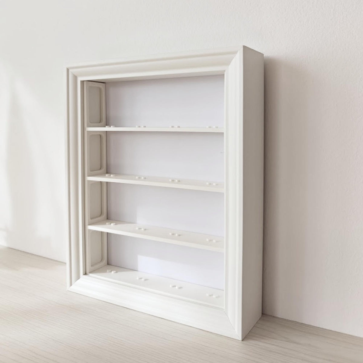 Side angle of empty vertical VÄSTANHED frame showing the white 3D printed shelf insert system.