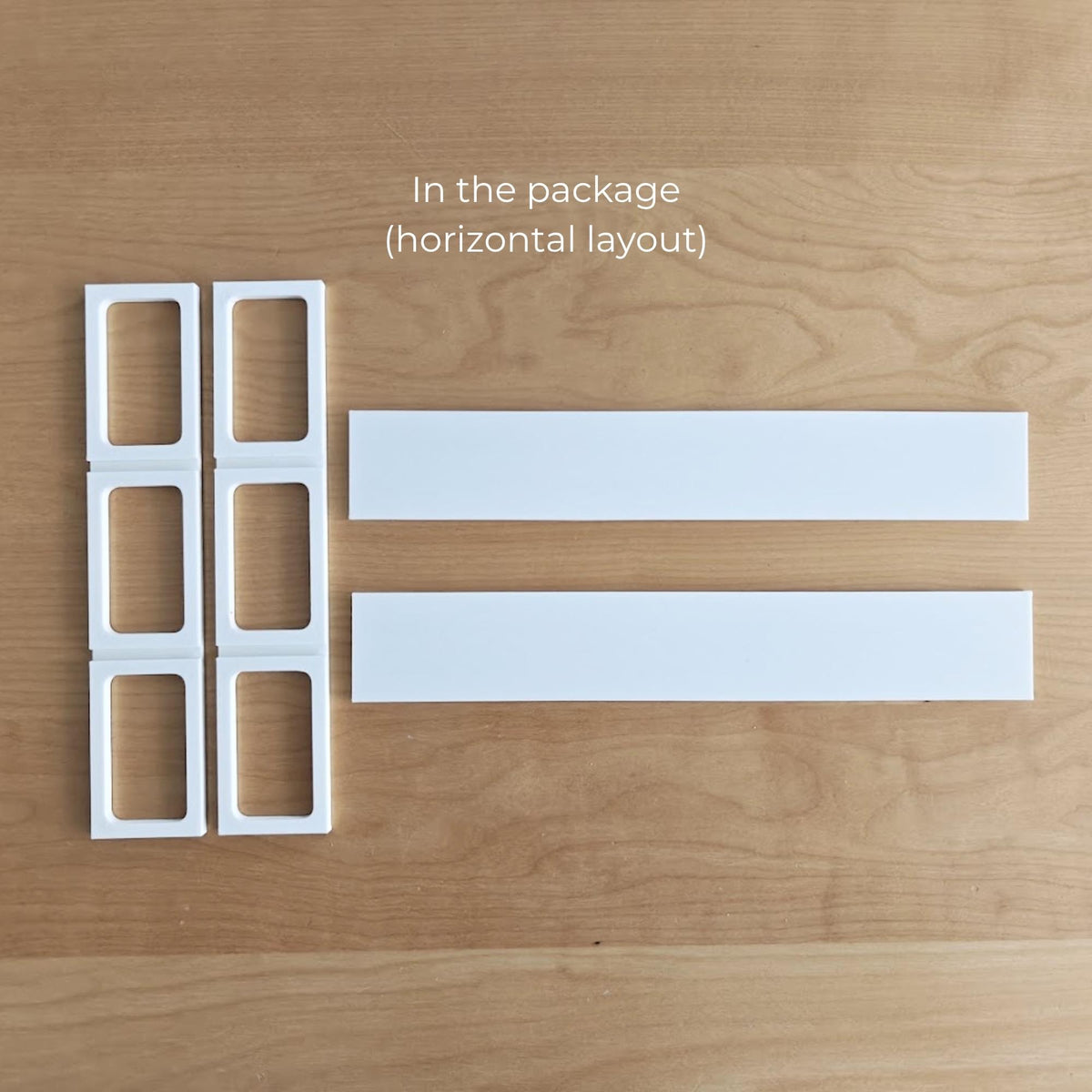 Parts included with the horizontal VÄSTANHED insert, including side grid supports and three display shelves.
