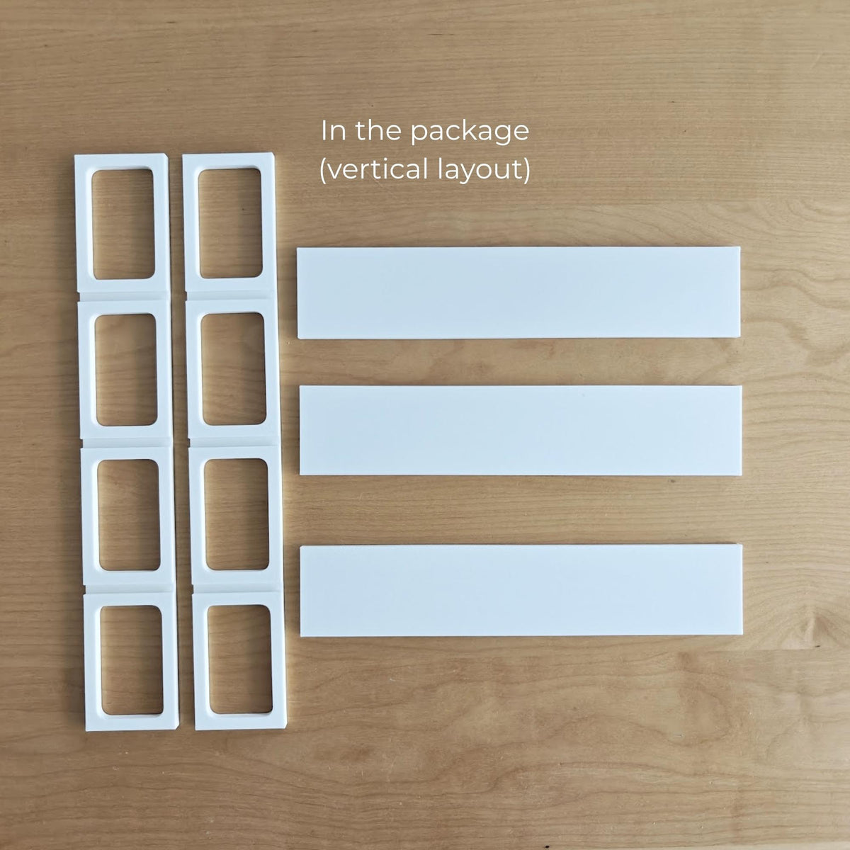 Parts included with the vertical VÄSTANHED insert, including side grid supports and four display shelves.