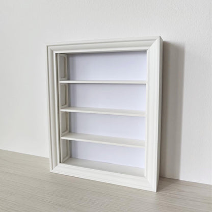 Angled view of empty vertical IKEA VÄSTANHED frame with white 3D printed shelf insert.