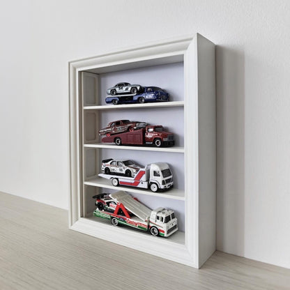 Angled view of vertical IKEA VÄSTANHED frame with white shelves displaying miniature cars.