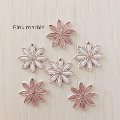Pink marble star anise ornaments in soft pink, white and marble-effect color combinations.