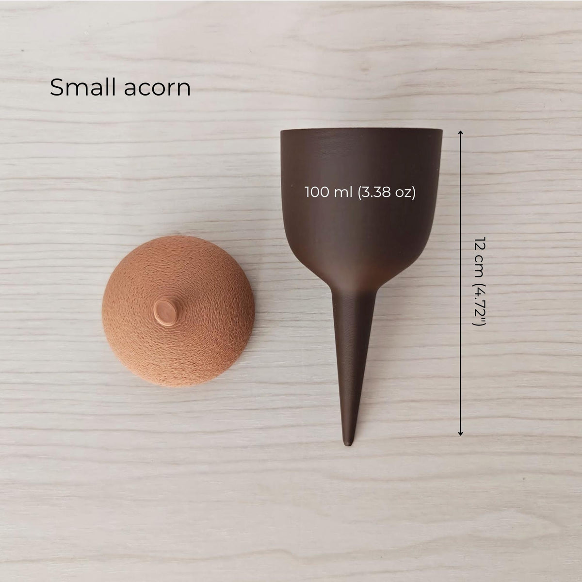 Small acorn plant watering container with removable lid, 100 ml capacity and 12 cm total height.