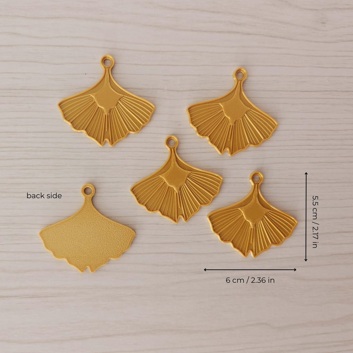 Set of five ginkgo leaf ornaments showing the detailed front, textured back, and approximate dimensions.