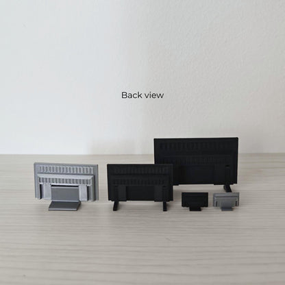 Back view of miniature TVs and stands showing the different support and leg designs.